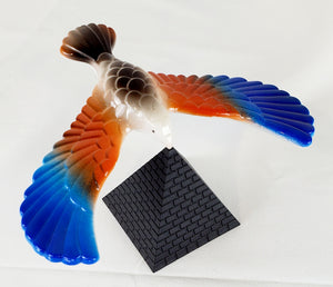 Balancing bird. In this toy, the mass in the forward-swept wings